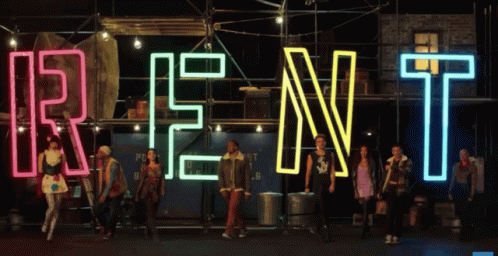 Group Standing In Front Of Rent Sign GIF