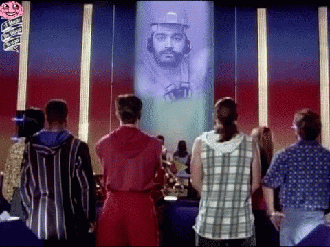 Group Standing In Front Of Screen With Man GIF