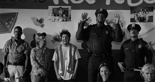 Group Standing in Front of Wall with Pictures