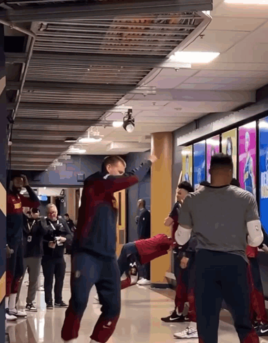 Group Standing in Hallway One in Nike Sweater