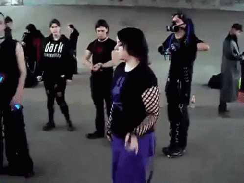 Group Standing In Room With Shirt Saying Dark GIF