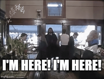 Group Standing in Room With Sign I'm Here