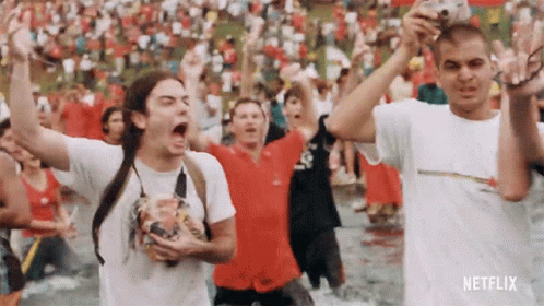 Group Standing in Water With Arms Up Netflix Logo