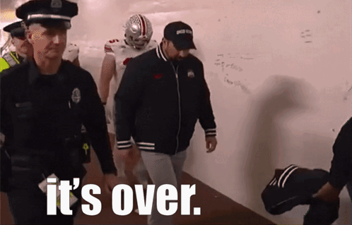 Group Walking Down Hallway It's Over