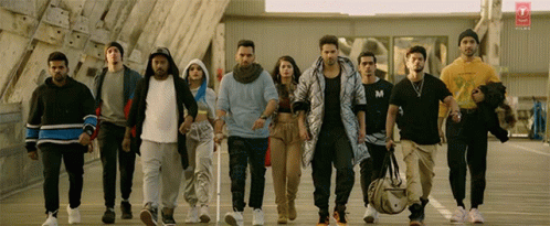 Group Walking Down Street One Wearing M Shirt GIF