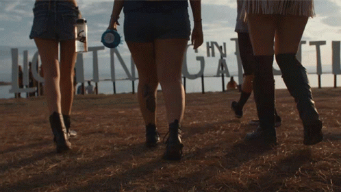 Group Walking Past Huntinggate Sign GIF