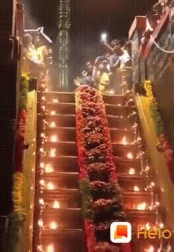 Group Walking Up Stairs With Lights and Flowers