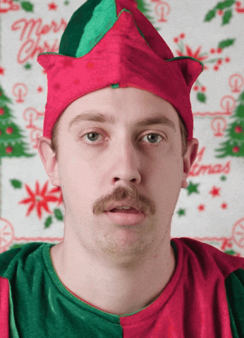 Guy Christmas Elf Spitting Gifts GIF