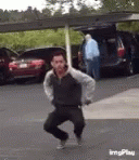 Guy Dancing Get Low With Hand Gestures On The Street GIF