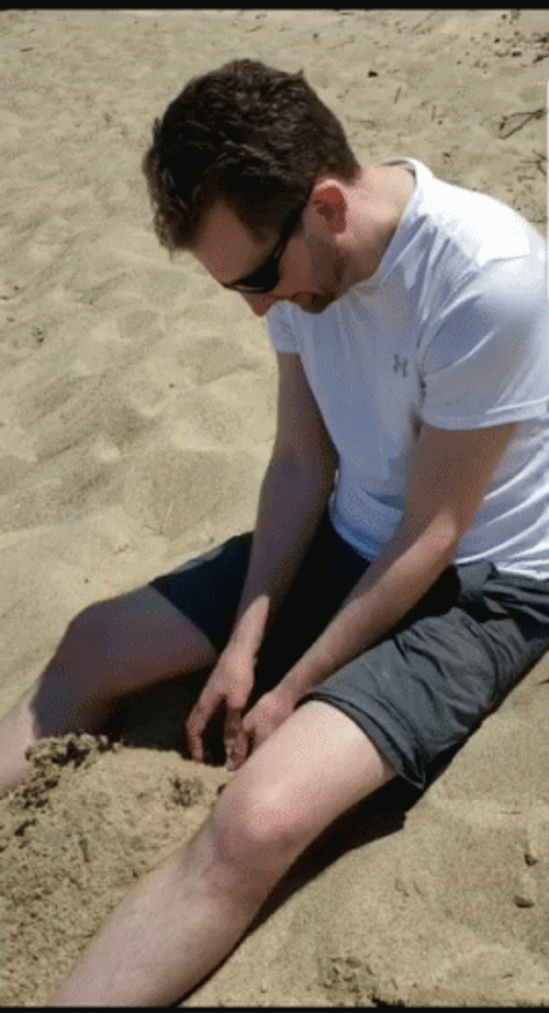 Guy Digging At The Beach GIF