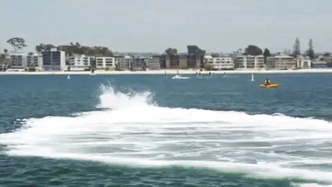 Guy Fly Boarding Near Parked Skiff GIF