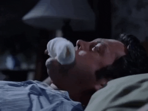 Guy Gagged While Lying In Bed GIF