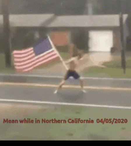 Guy Holding American Flag Waving Strongly GIF