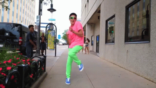 Guy In Colorful Outfit Walking Funnily GIF