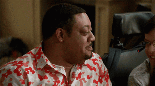 Guy In Floral Polo Holding In Laugh GIF