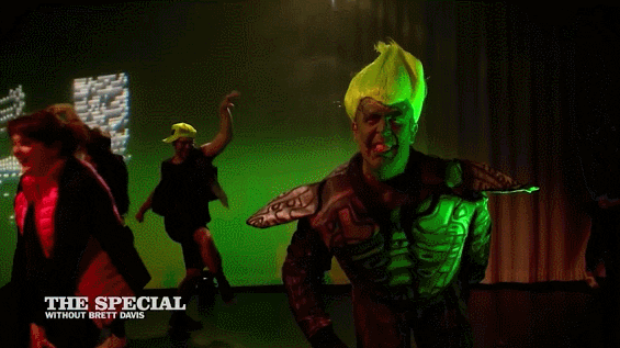 Guy In Green Goblin Shark Costume Sing GIF