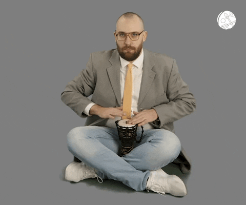 Guy In Suit Doing Rim Shot GIF