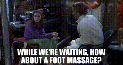 Guy Offering Foot Massage While Waiting GIF