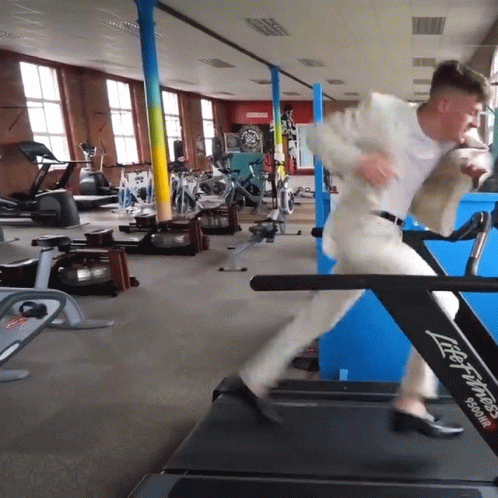 Guy On A Suit Running On Treadmill GIF