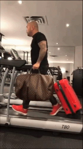 Guy Running On Treadmill With Luggage To Airport GIF