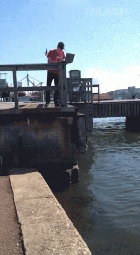 Guy Throwing Computer Laptop In The Water GIF