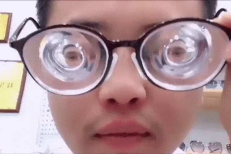 Guy Wearing Intense High Graded Glasses GIF