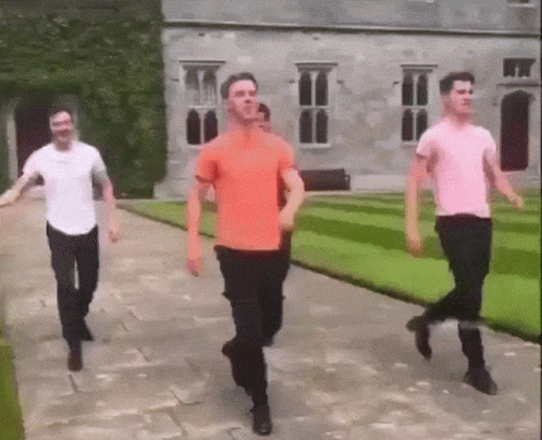 Guys Carrying Out Irish Jig In A Garden GIF