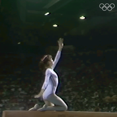 Gymnast Doing Trick on Balance Beam