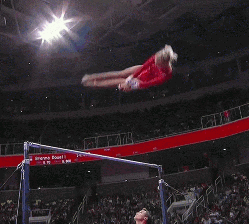 Gymnast Doing Trick on Uneven Bars