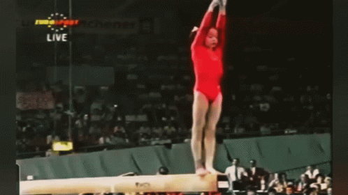 Gymnast Performing Trick on Balance Beam