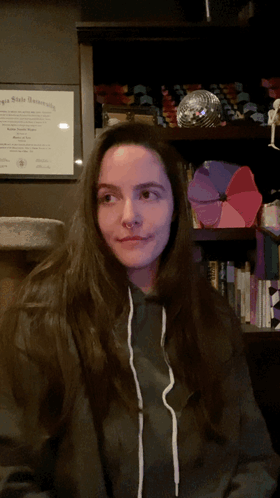 Hair Tuck Woman Wearing Hoodie GIF