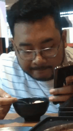 Hakuna Matata Asian Guy Eating While On Phone GIF
