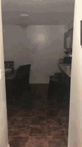 Hallway Leading to Dark Room With Ceiling Fan