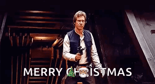 Han Solo Is Holding A Gun And Saying Merry Christmas While Standing In A Room . GIF