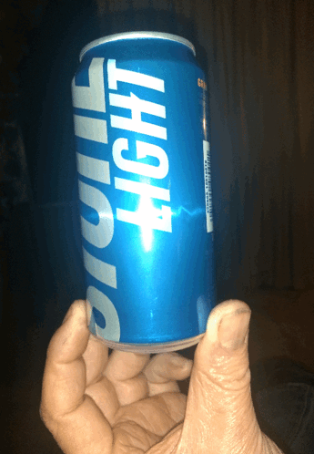 Hand Holding Blue Light Can