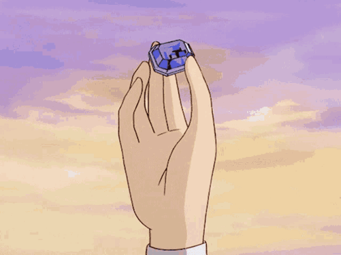 Hand Holding Blue Object With Letter X