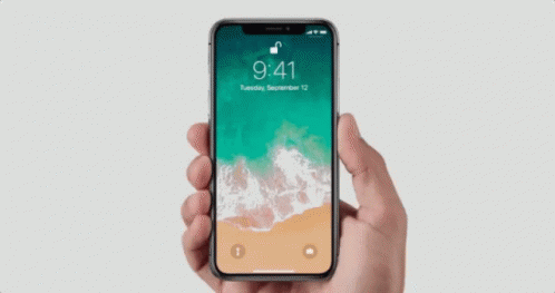 Hand Holding Cell Phone Green Brown Background
