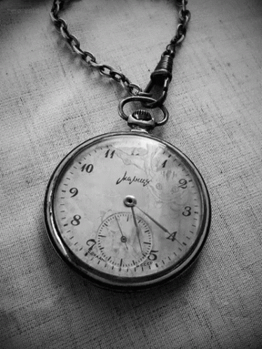 Hand Holding Clock Showing 1 and 5