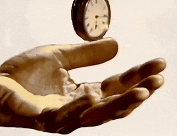 Hand Holding Clock Showing 1 and 5