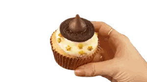 Hand Holding Cupcake with Oreos and Kiss