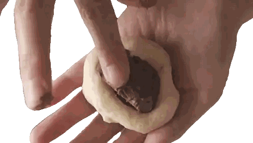 Hand Holding Dough With Chocolate