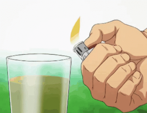Hand Holding Lighter Next to Glass of Liquid