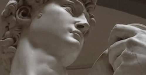 Hand Holding Man Statue Eyes Closed