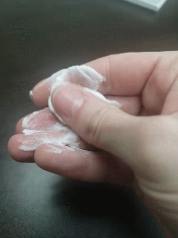 Hand Holding White Liquid GIF