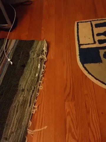 Hand Making OK Sign in Front of R2D2 Rug