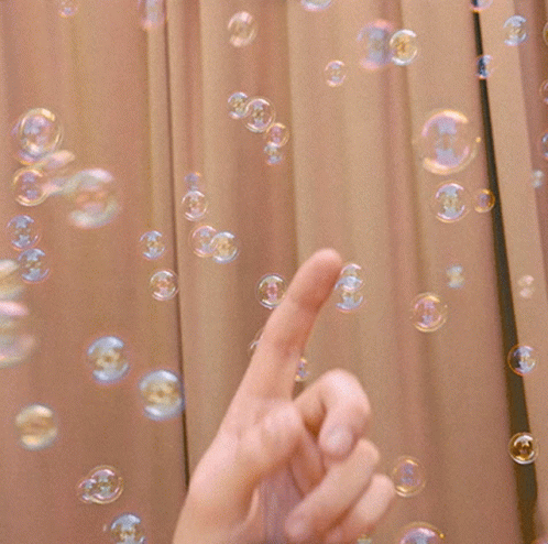 Hand Pointing at Soap Bubbles