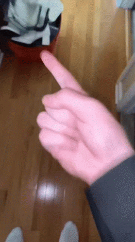 Hand Pointing to Trash Can