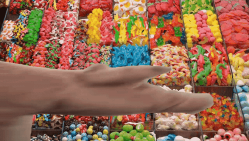 Hand Reaching For Candy Display GIF