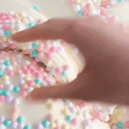 Hand Reaching for Cookie With Sprinkles