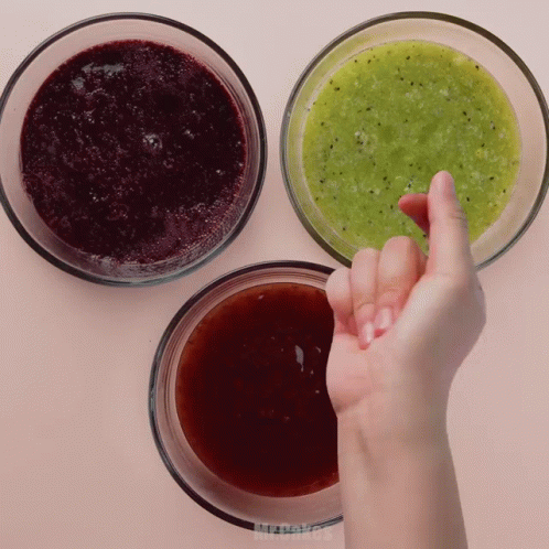 Hand Reaching for Green Sauce in Bowl